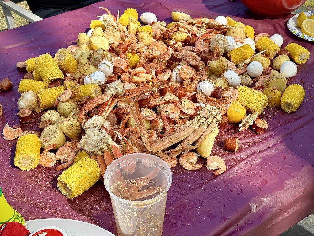 Low country boil with shrimp, crab legs, corn, potatoes, boiled eggs and pork sausage.